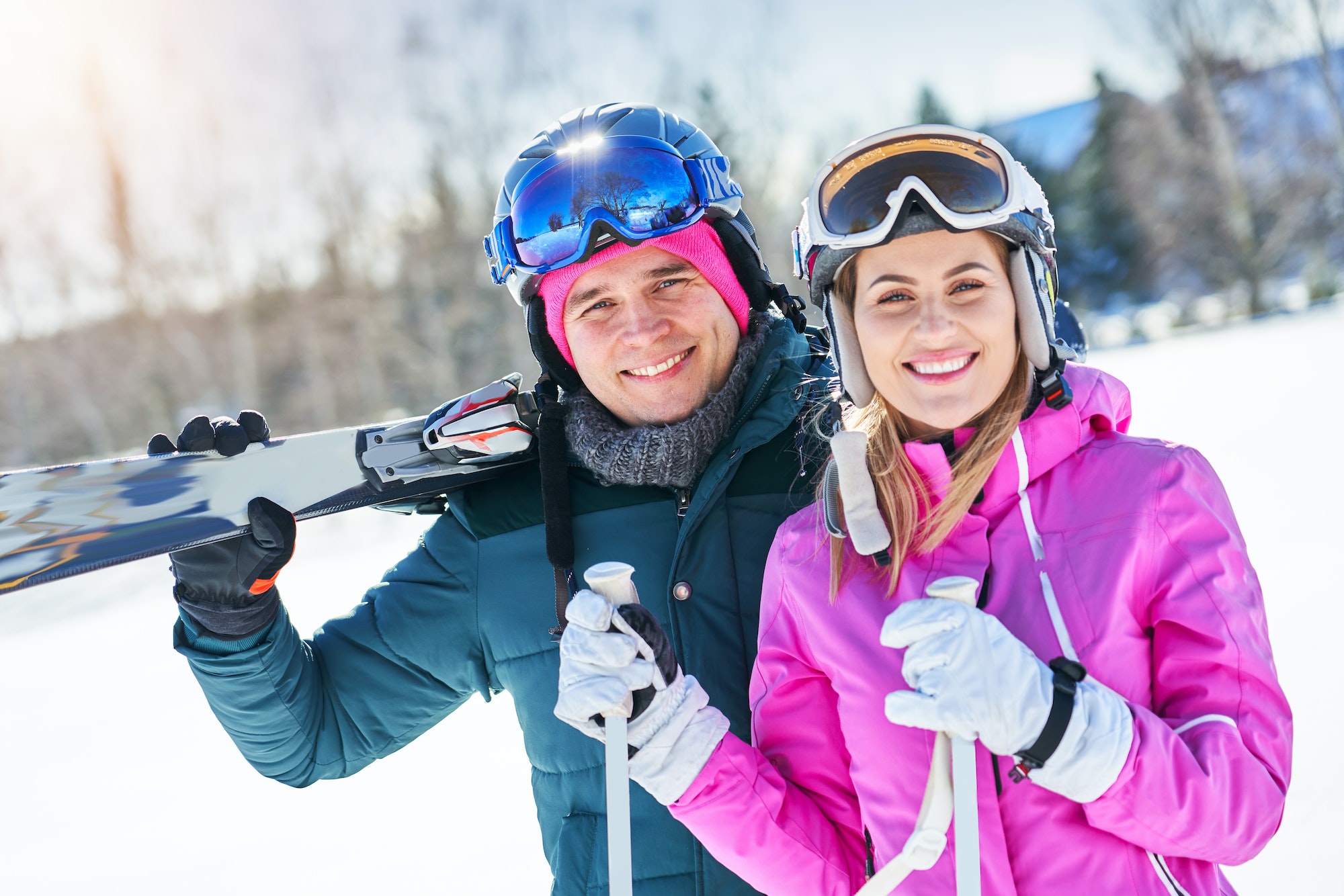 Young couple having fun while winter skiing